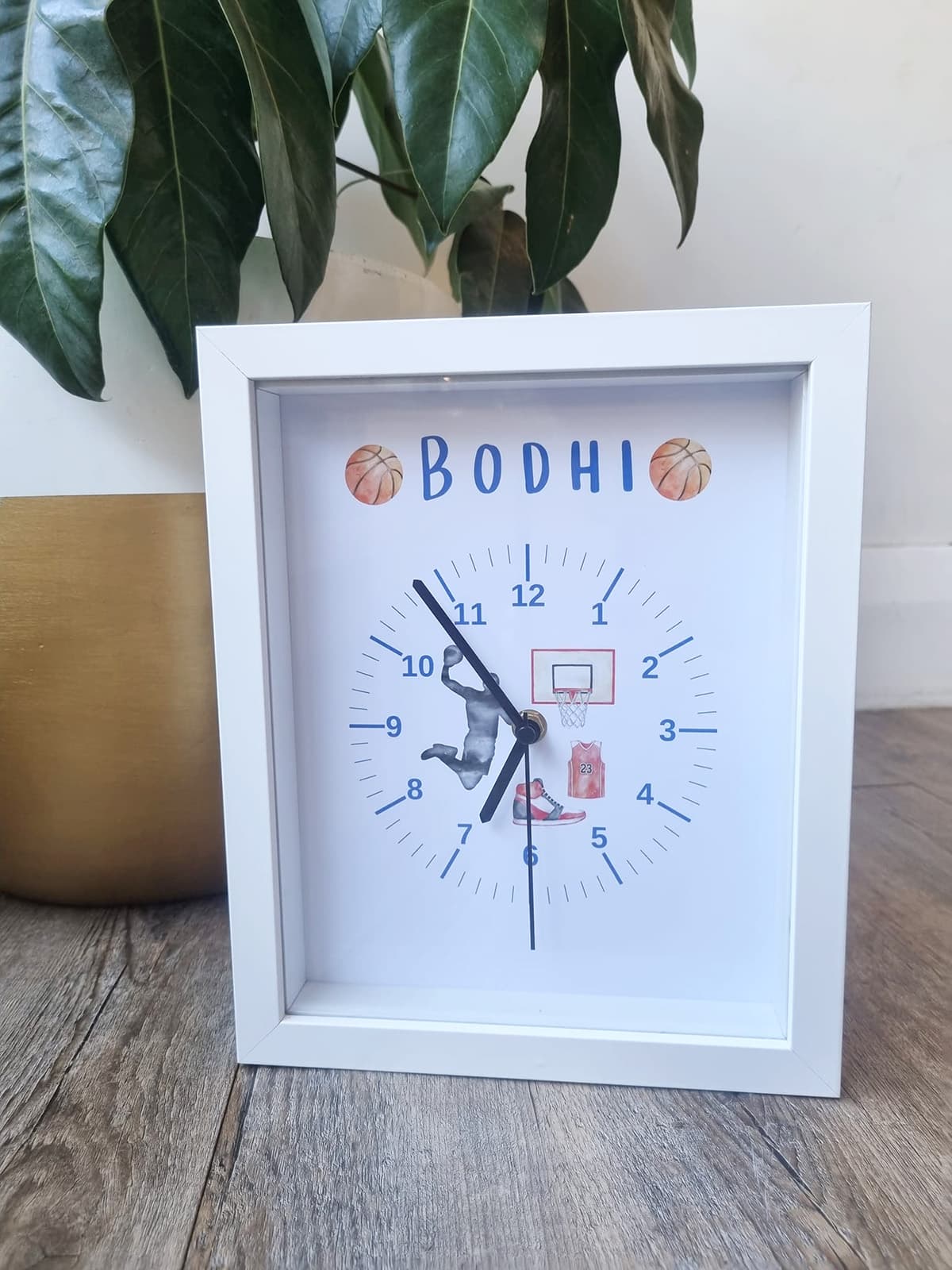 Clock sitting on table with an image of basketball players within it