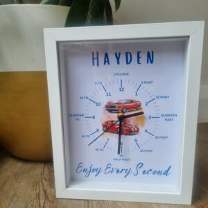 Personalised learning clock with vintage cars in the middle sitting on a side table